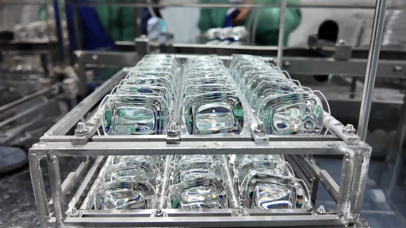 Rows of formed glass optical components staged in a BO-Glass production rack