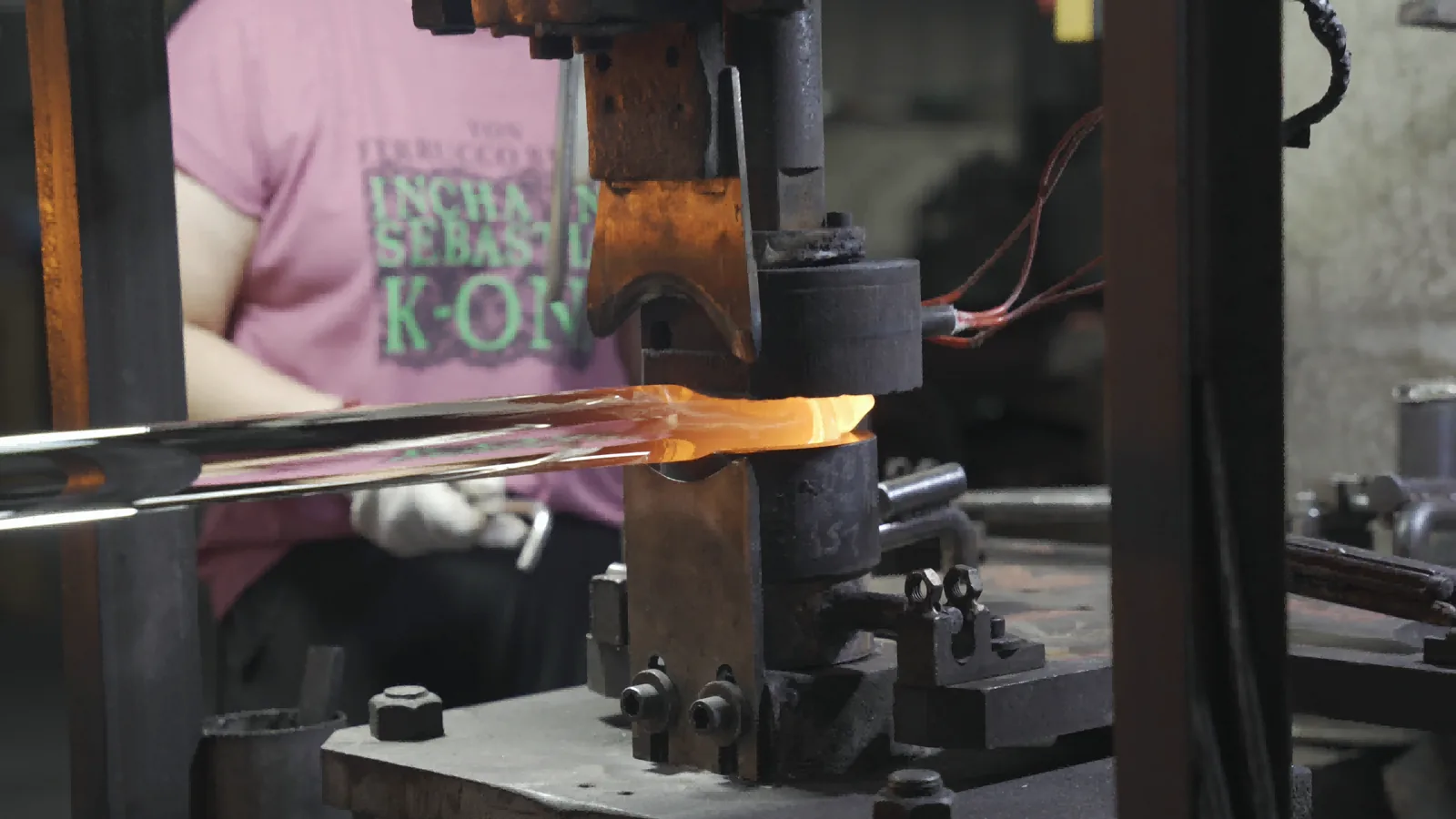 Heated optical glass being formed in controlled production tooling at BO-Glass