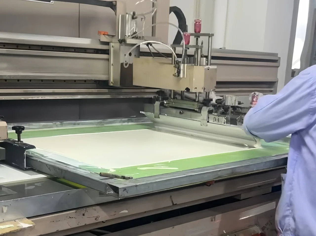 Large production screen and press setup for printing a glass panel.