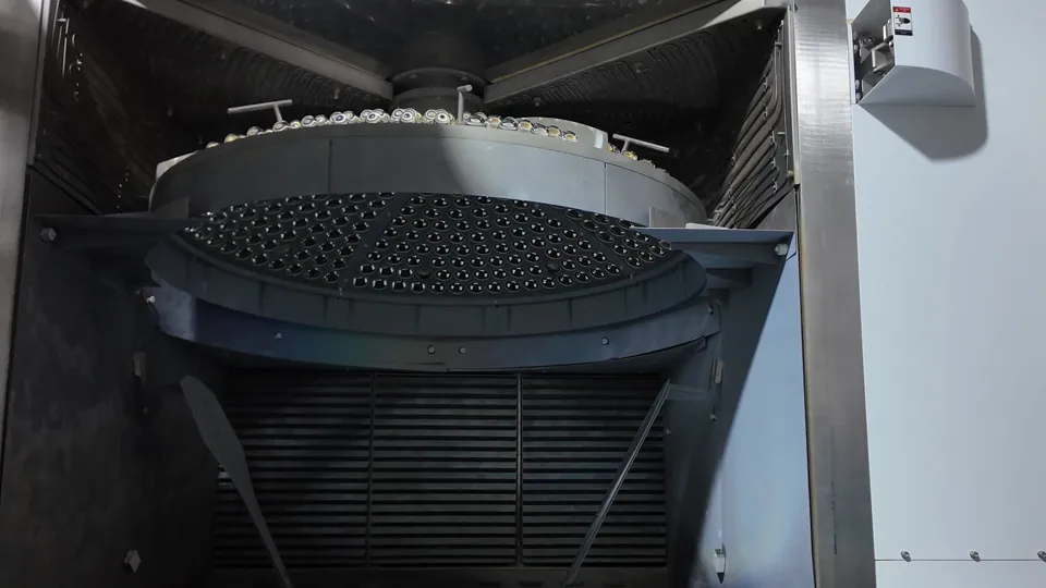 Optical glass parts loaded on multi-level fixtures inside a vacuum coating chamber