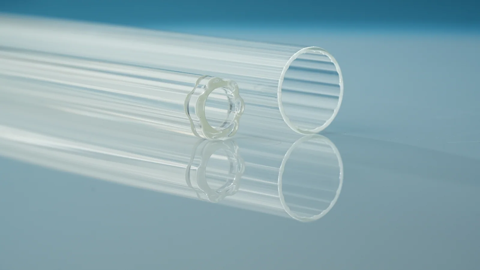 Two clear hollow glass tubes with different cross-sections, with their open ends visible.