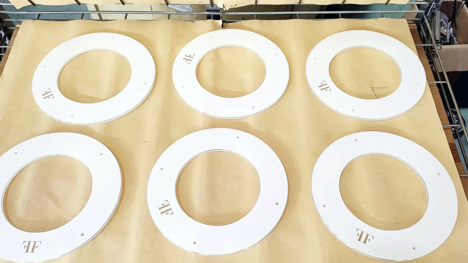 Real batch of circular printed glass components staged during production.