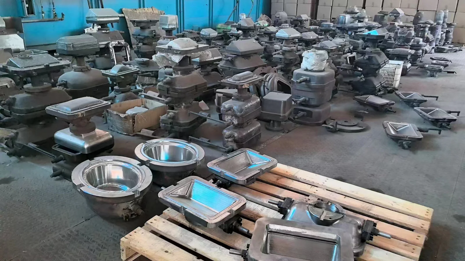 Glass pressing moulds of different shapes arranged in a workshop