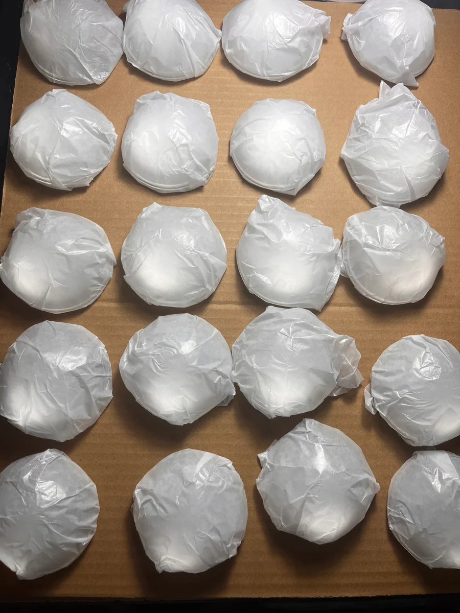 Circular components individually protected in white wrapping before packing