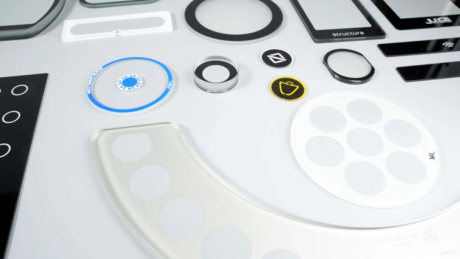 Real screen-printed glass products showing black, white, blue and yellow ink coverage.