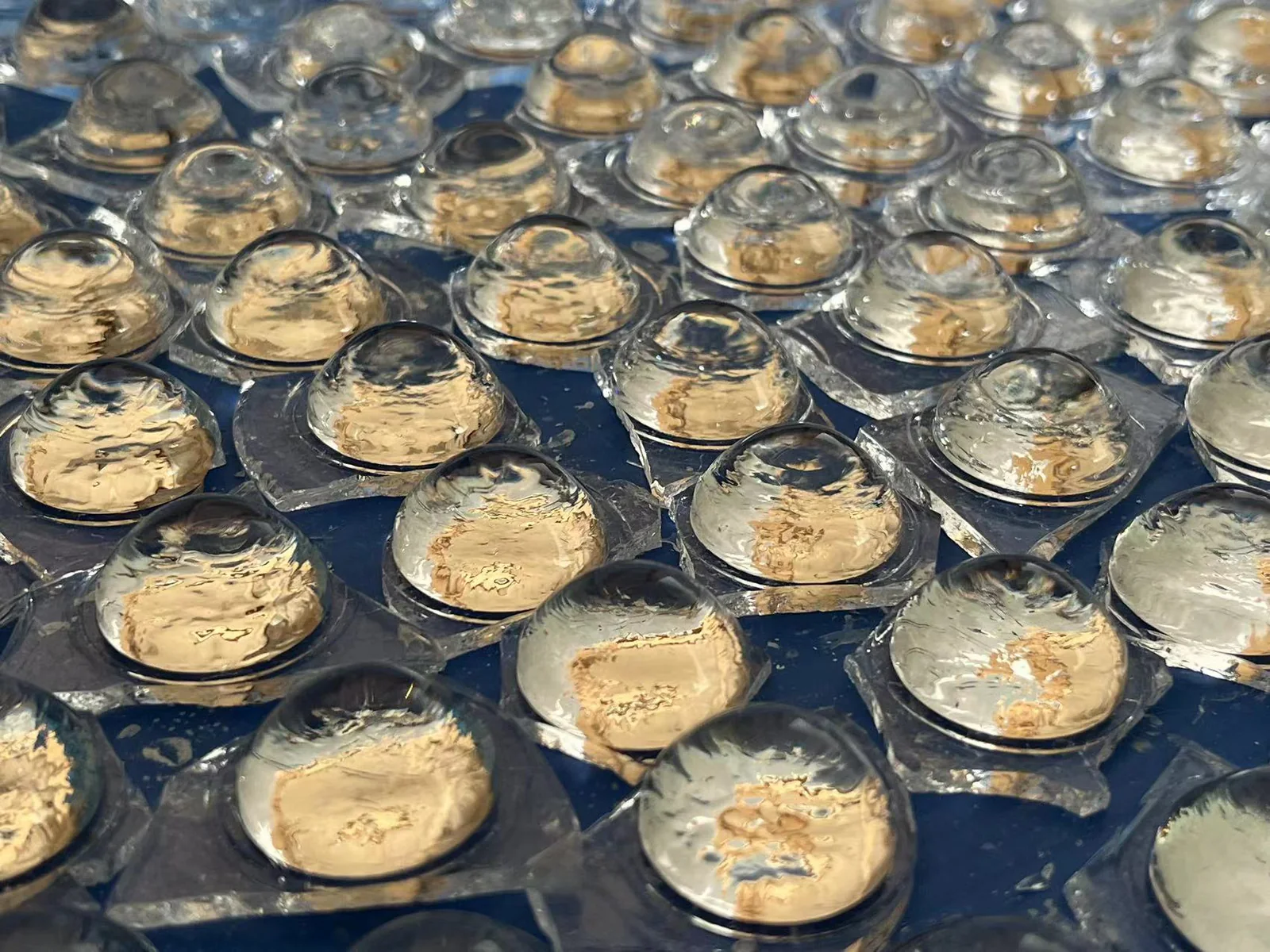 Batch of moulded glass lens blanks before edge removal and finishing