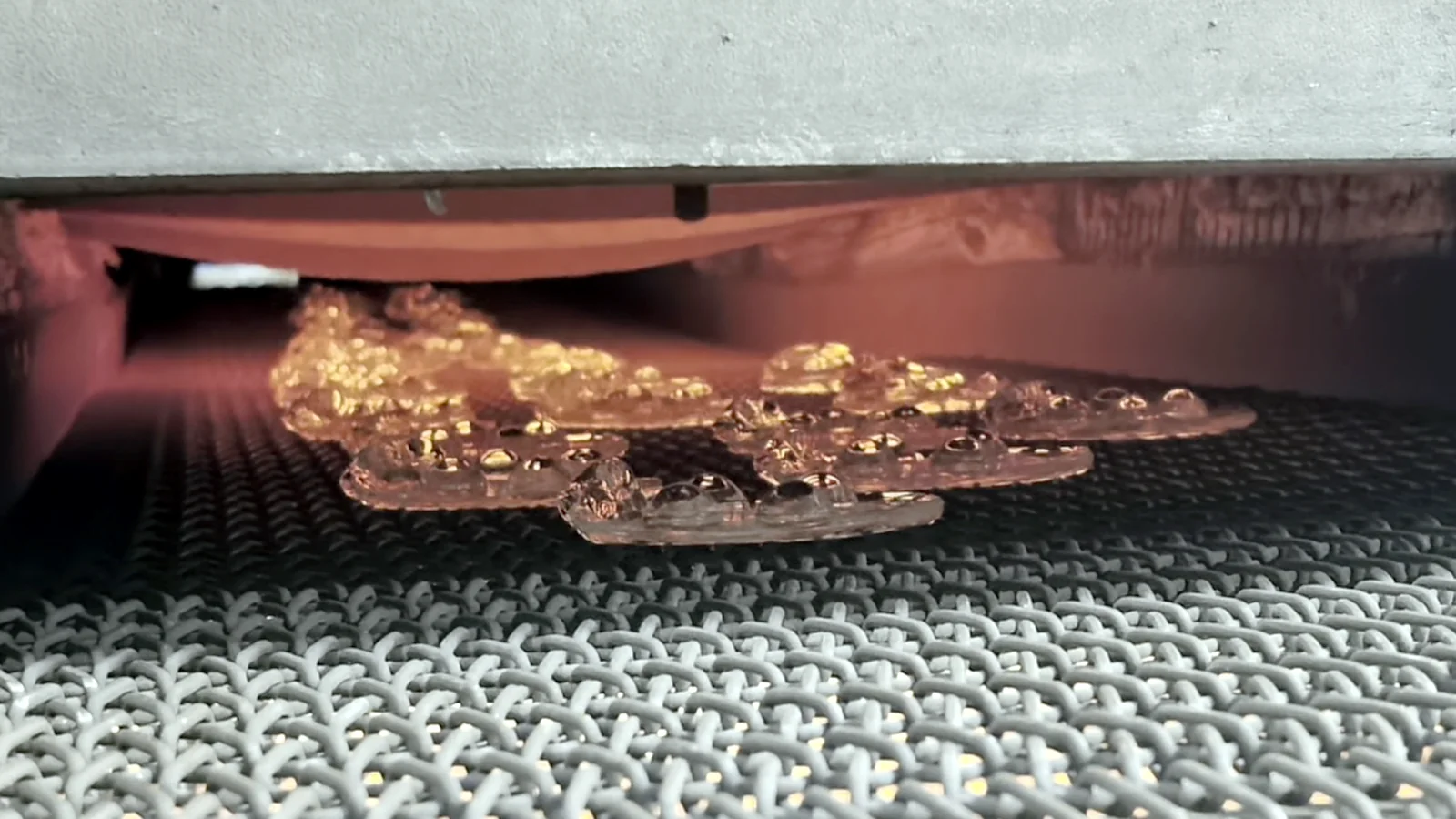 Glass components on a conveyor at a heated production line