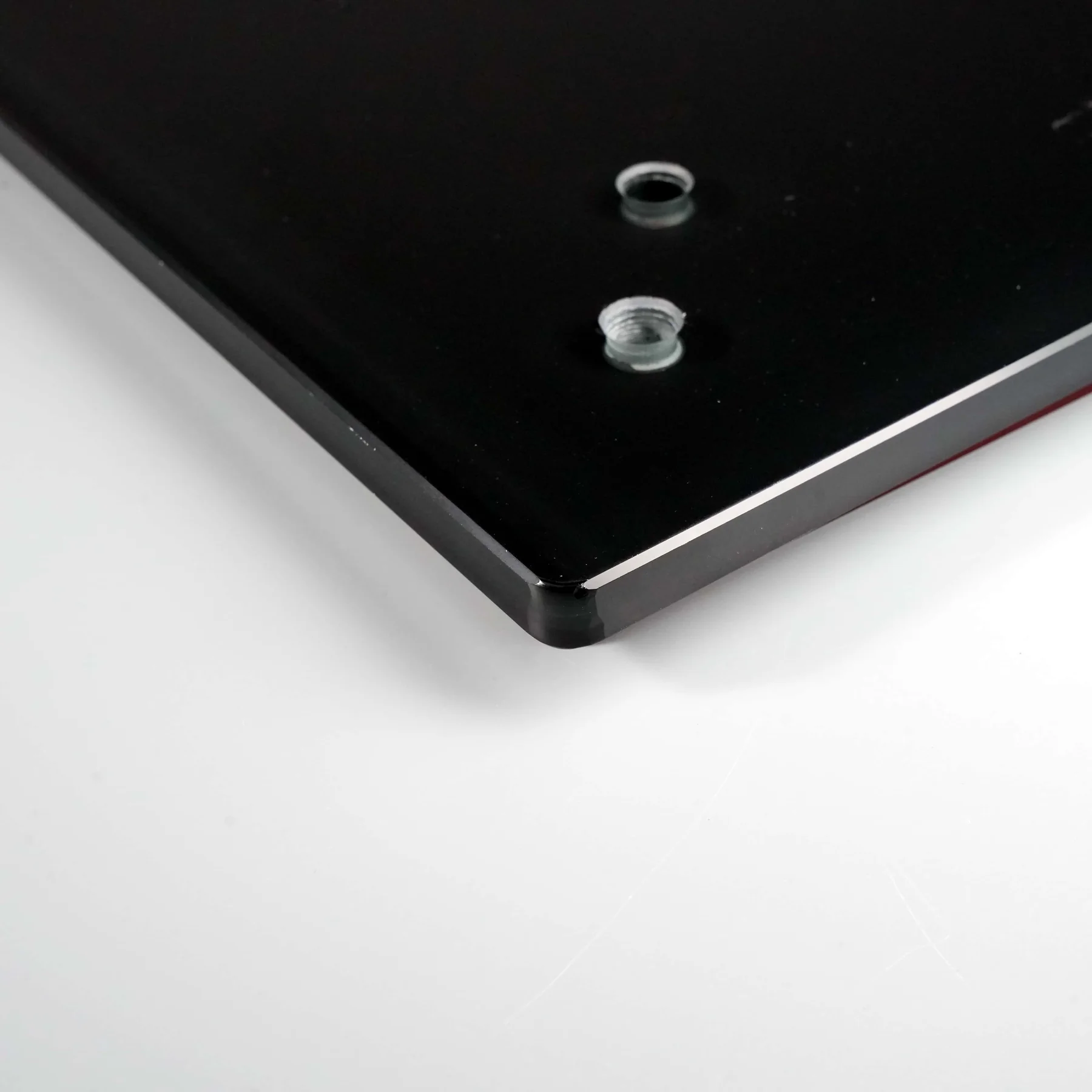 Real black printed glass panel with a machined opening and threaded insert detail.