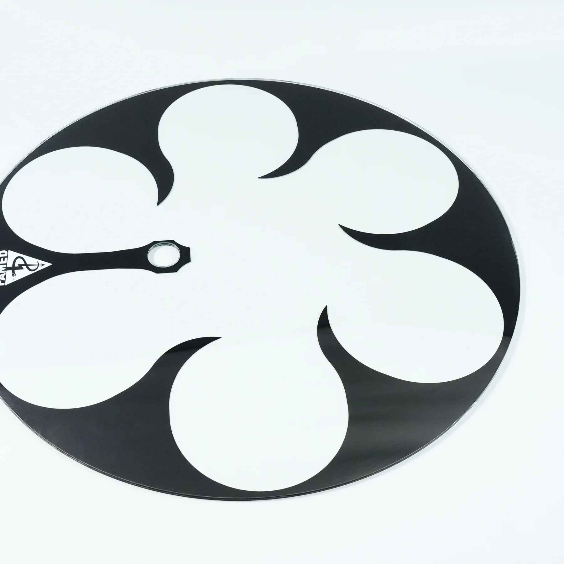 Real circular glass component with an irregular floral screen-printed pattern and central opening.