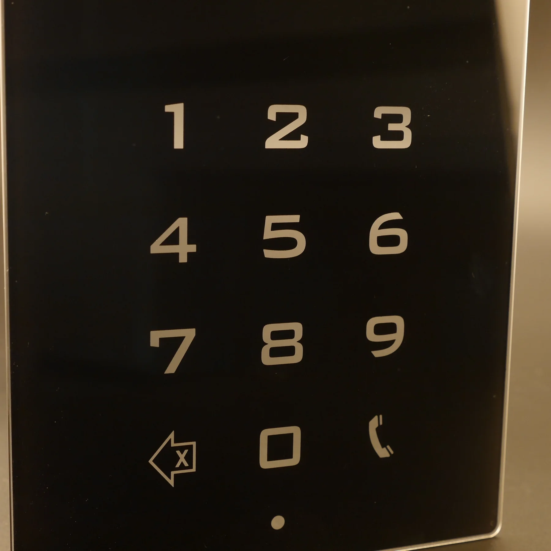 Real metallic keypad graphics on cover glass, where contrast changes with lighting and viewing conditions.