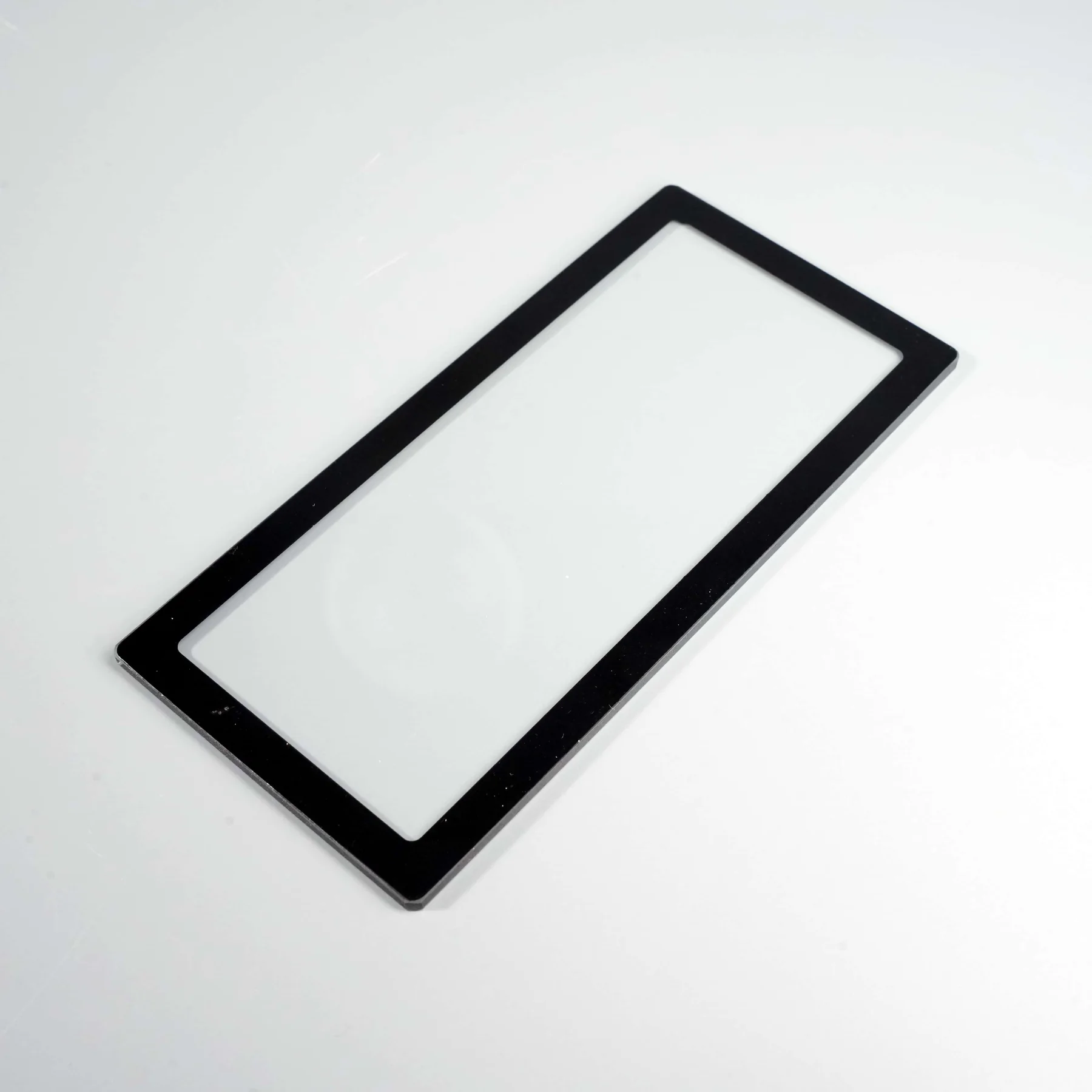 Real rectangular cover glass with an opaque black border for edge-definition and deposit-uniformity inspection.