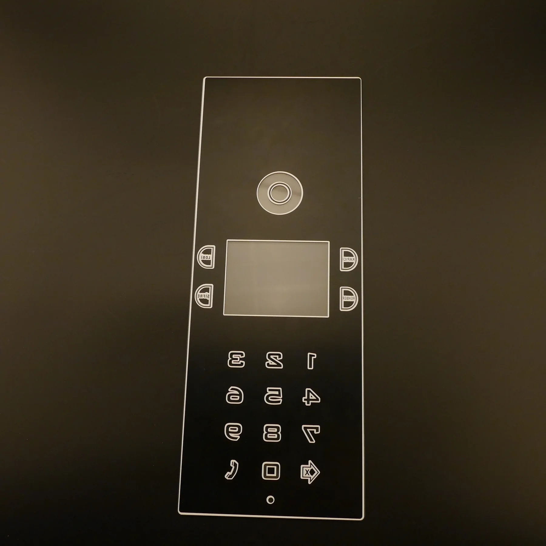 Real reverse-side printed control-panel glass viewed from the unprinted face.