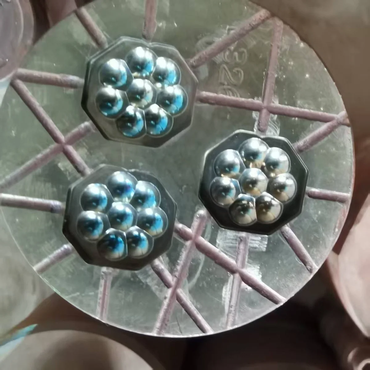 Three groups of repeated rounded features within a circular forming tool