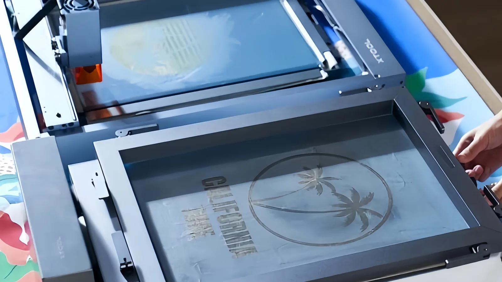 Real stencil-preparation equipment with screen frames positioned for image transfer.